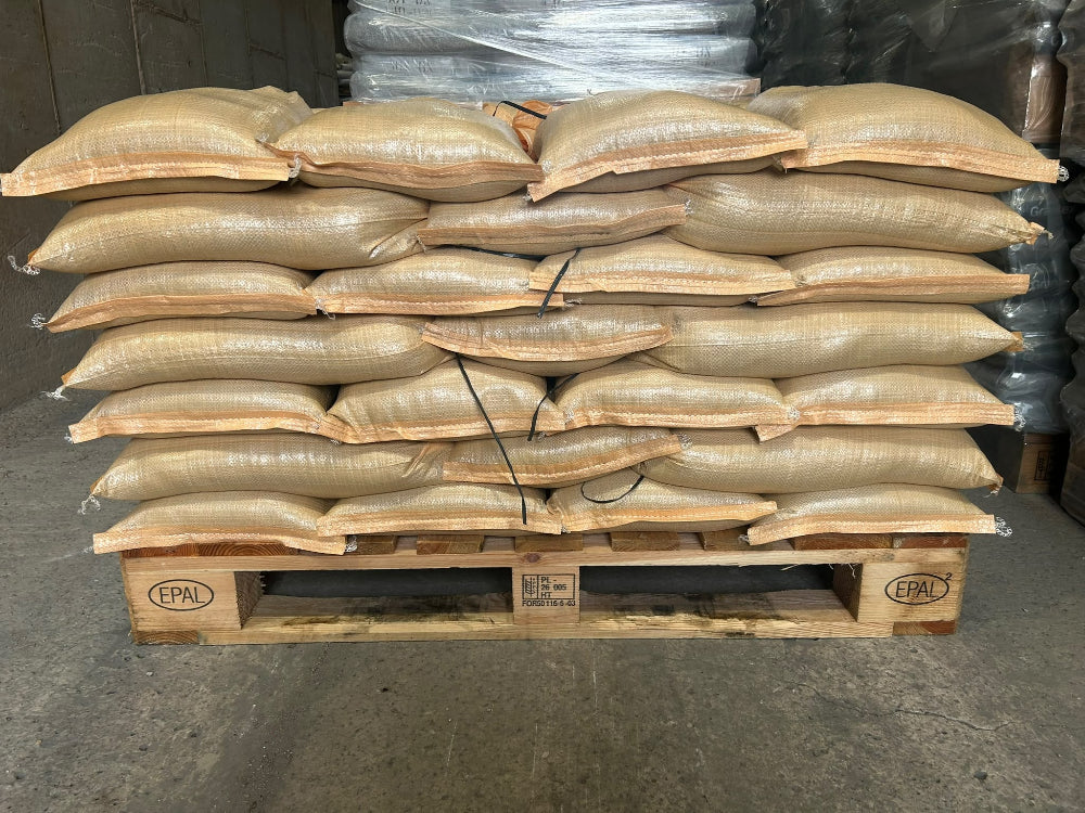 A wooden pallet stacked with flood defence sandbags
